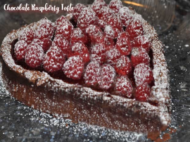 Chocolate Raspberry Torte is a decadent, fudgy dessert, topped with raspberry glaze, fresh raspberries and powdered sugar! It tastes amazing!