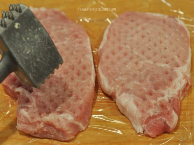 Boneless pork chops are tenderized using a meat mallet.