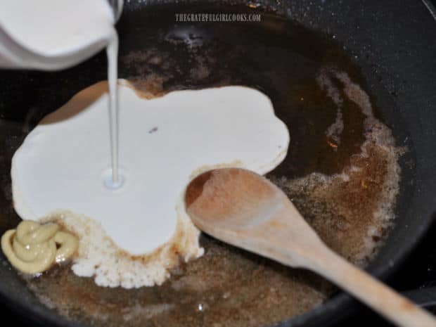 Whipping cream, honey and Dijon mustard are added to the skillet to make a sauce.