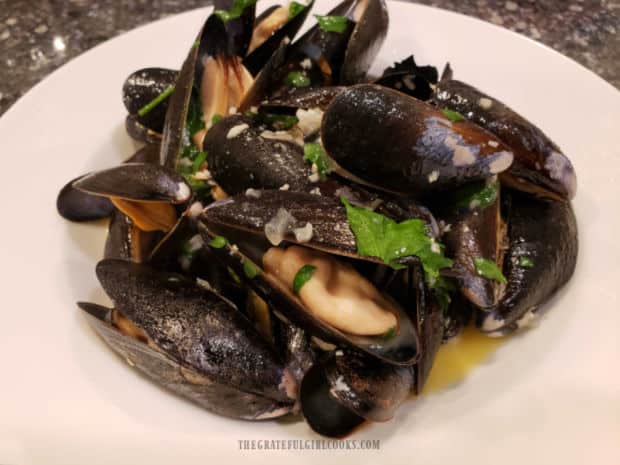 Mussels in Wine Garlic Butter Sauce in a bowl, and are ready to be eaten.