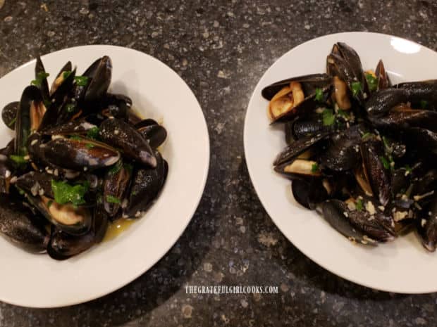 Two bowls full of mussels in wine garlic butter sauce, ready to be served.