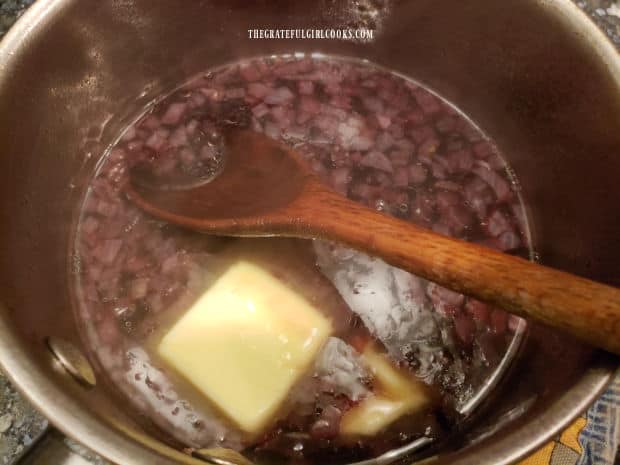 Butter is added to the red wine and shallot reduction sauce.