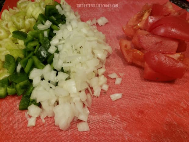 Celery, green bell pepper, onions and tomatoes are prepped for the smothered turkey patties.