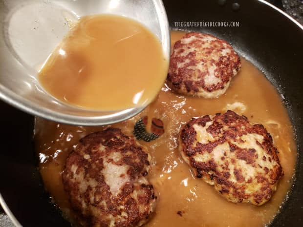 Sauce is poured over the top of the patties.