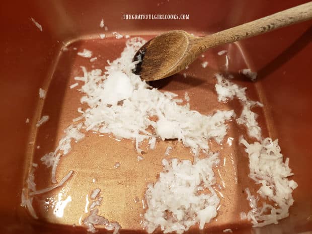 Shredded coconut is cooked in coconut oil until lightly "toasted".