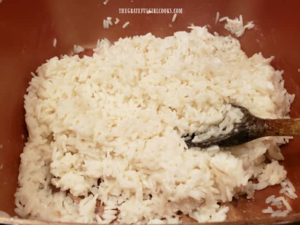 Creamy coconut rice is removed from heat when coconut milk is absorbed and rice is tender.
