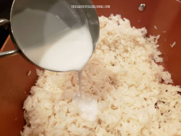 Reserved Tablespoons of coconut milk are added to finished rice, and combined, before serving.
