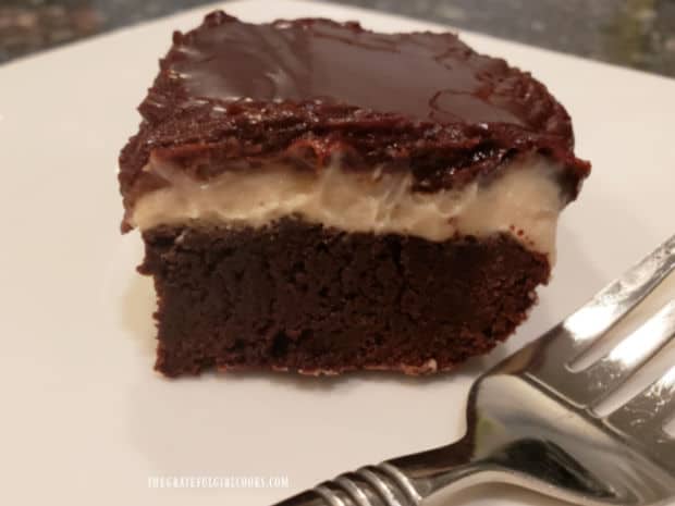 One of the Irish cream layered brownies on a white plate, ready to be eaten.