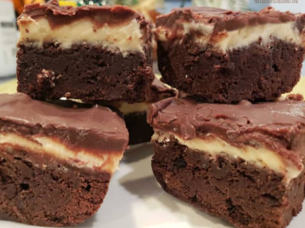 A stack of Irish cream layered brownies, ready to eat on a white plate.