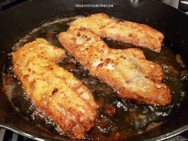 Golden brown Krispy rockfish fillets frying in hot oil.