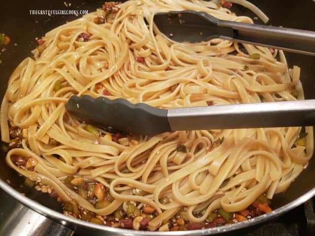Hot drained pasta is added to the Szechuan sauce, creating simple Szechuan noodles.