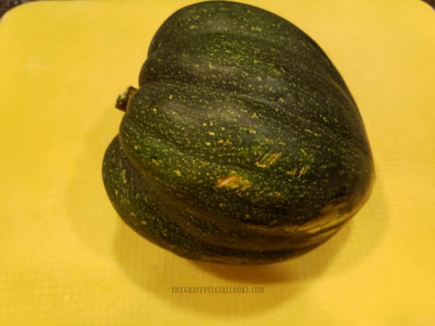 One acorn squash ready to be prepared for baking.