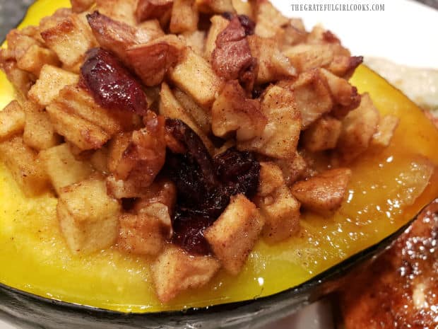 A close up picture of the apple pecan stuffed acorn squash, with cranberries.