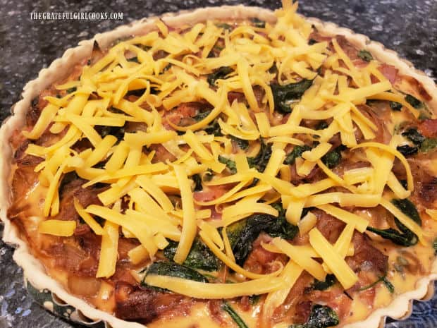 After baking, cheese is sprinkled on top of the tart and placed under broiler to melt it.