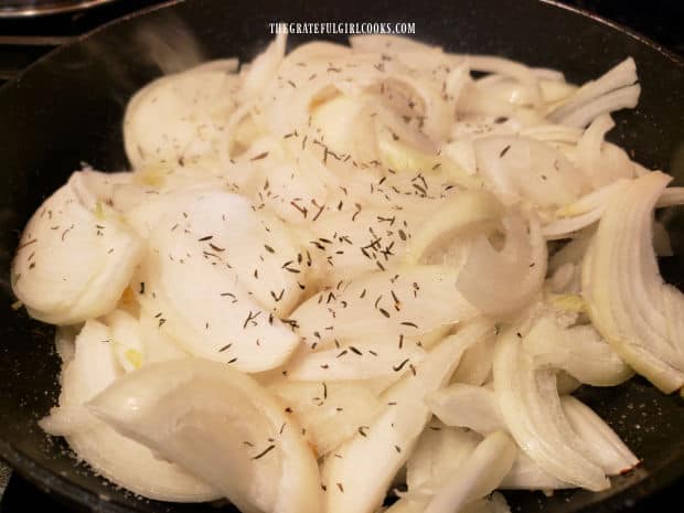 Sliced onions, salt and thyme are placed in large skillet to cook.