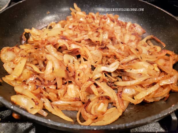 Once caramelized, the onions in the skillet become brown in color.