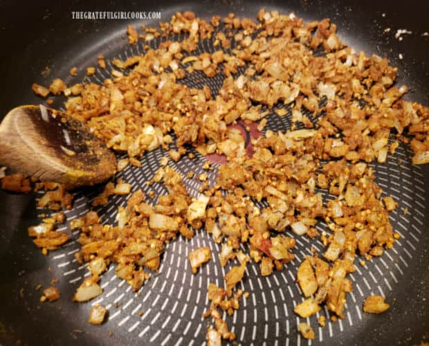 Onions, ginger, garlic and curry spices cook together in skillet for 1 minute.