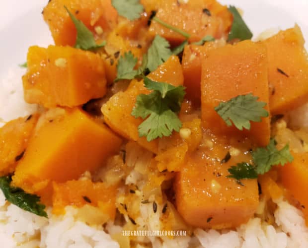 The butternut squash is tender and is garnished with chopped cilantro for serving.