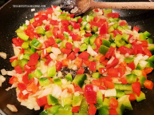 Bell peppers and onion continue to cook in skillet until charred and tender.