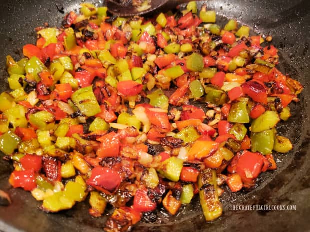 When done cooking, the onions and bell peppers are charred on the outside and tender.