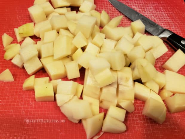 Russet potatoes are peeled, then cut into 1/2" cubes before cooking.