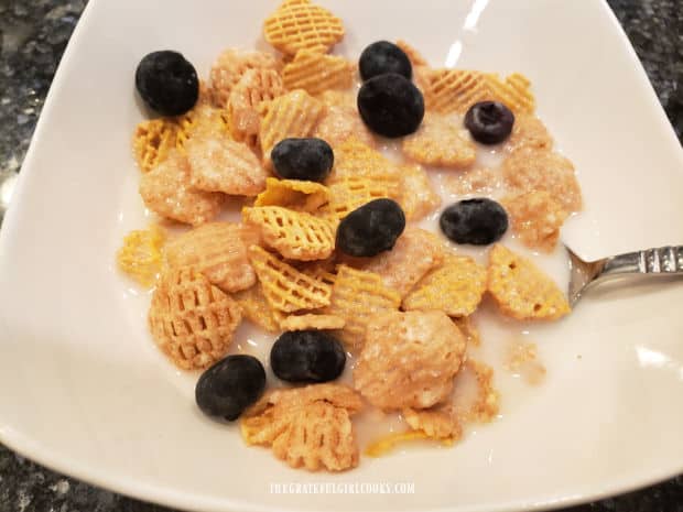 A bowl of cereal topped with some of the oat milk is ready to eat.