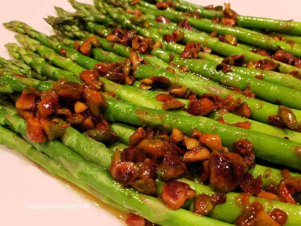 A close up photo of the Pistachio Asparagus In Orange Sauce.