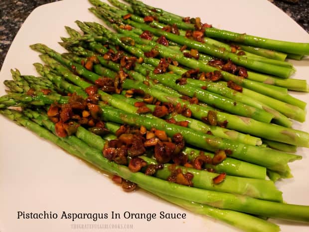 Pistachio Asparagus In Orange Sauce is a delicious, simple side dish! Steamed asparagus is topped with browned butter orange/pistachio sauce.