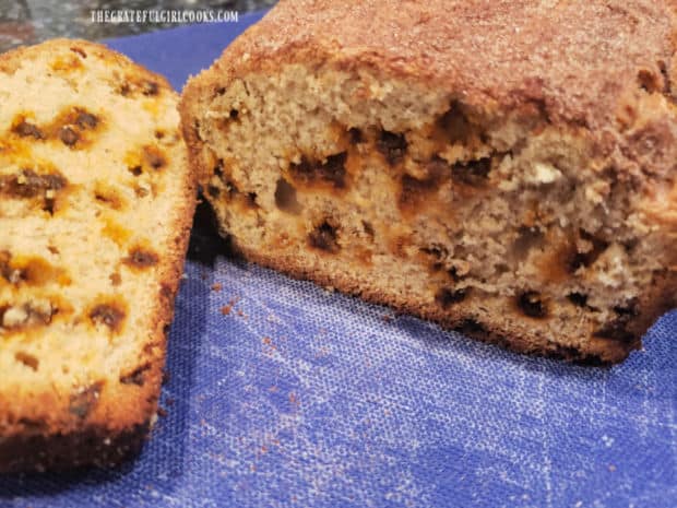 A slice of snickerdoodle bread next to the remaining loaf.