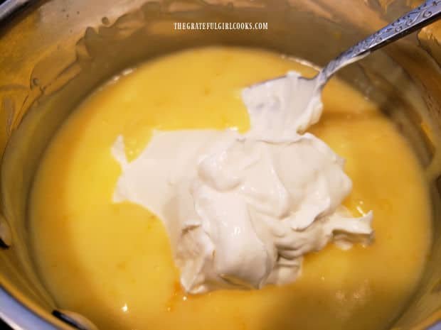 Sour cream is folded into the cooled lemon filling.