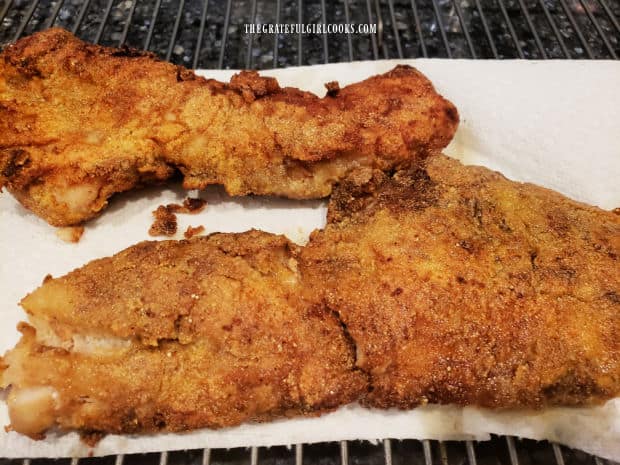 The Southwestern fried rockfish is drained on paper towels to absorb oil after frying.