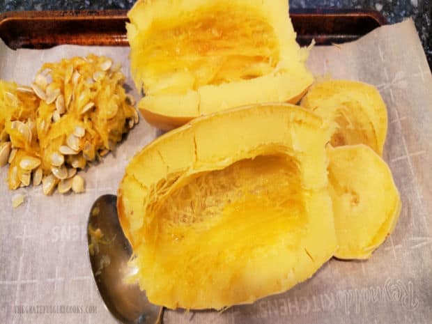 Seeds are removed from the spaghetti squash after it is roasted.