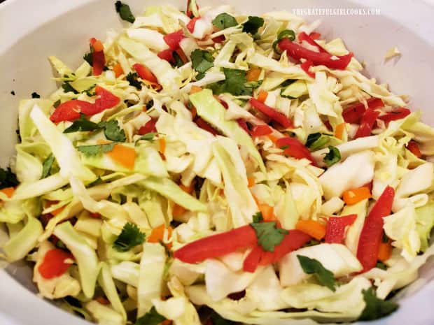 The Thai coleslaw ingredients are tossed together until combined.