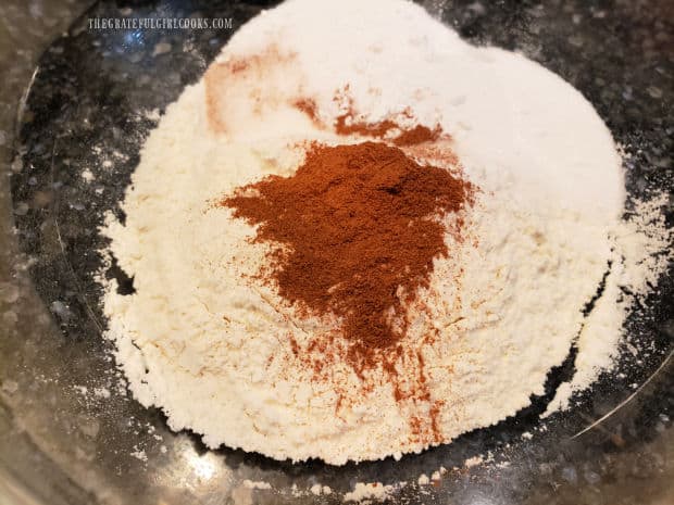 Flour, sugar, baking powder, cinnamon and salt are placed in a medium bowl and combined.