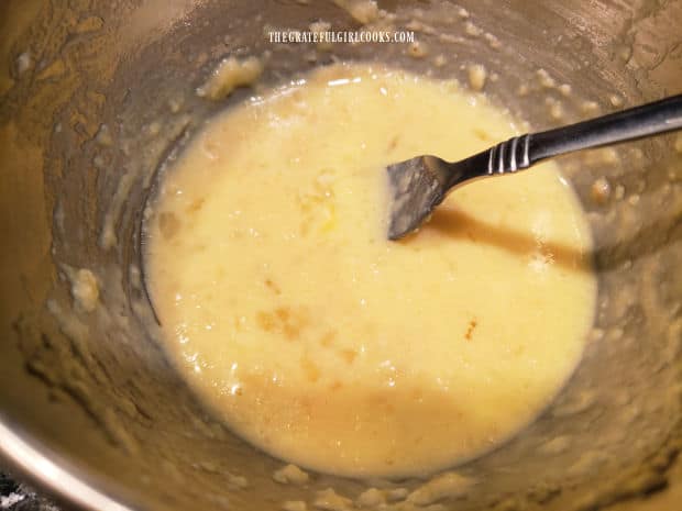 Egg, banana, buttermilk, vanilla and melted butter are combined in bowl.