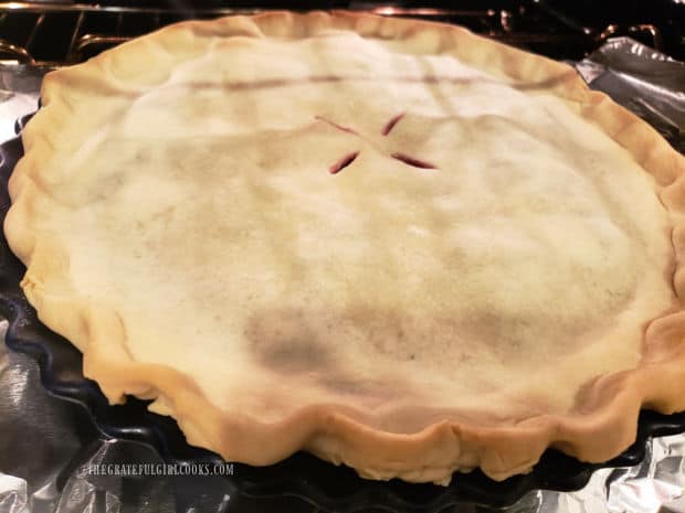 Partway through the baking time, the crust is turning golden in color.