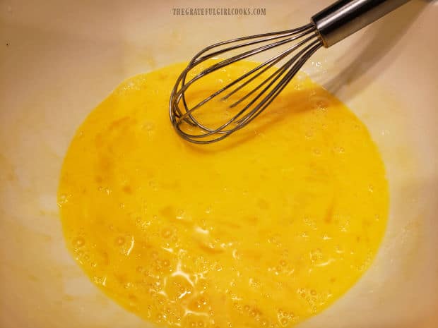 Eggs are whisked in a medium bowl before adding other ingredients.