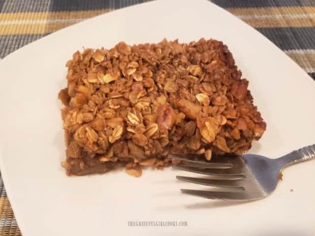 A portion of the pecan pie baked oatmeal, served on a white plate.