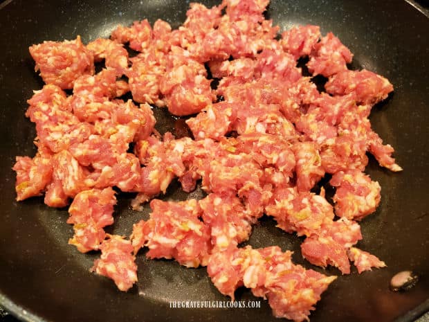 Italian sausage is crumbled and cooked in skillet.