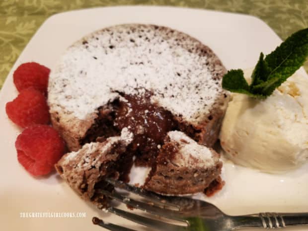 Hot melted chocolate oozes out of the air fryer chocolate lava cake once cut.
