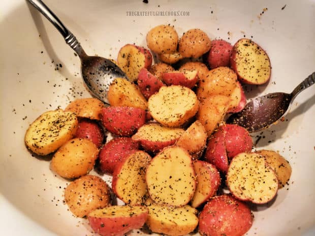 The mini potatoes have been tossed with olive oil and seasonings and are ready to cook.