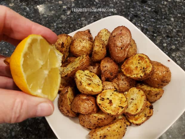Fresh lemon juice is squeezed over the hot mini potatoes before serving.