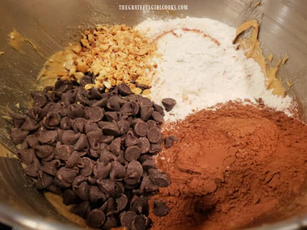 Cocoa powder, chocolate chips, flour, salt and peanuts are stirred into the brownie batter.