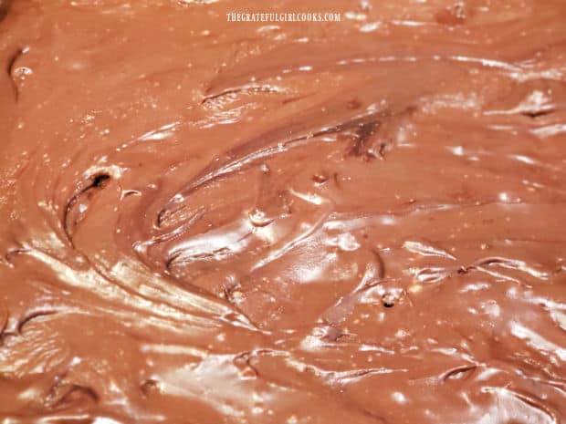 Holes are poked in the brownies, then they're covered with chocolate frosting.