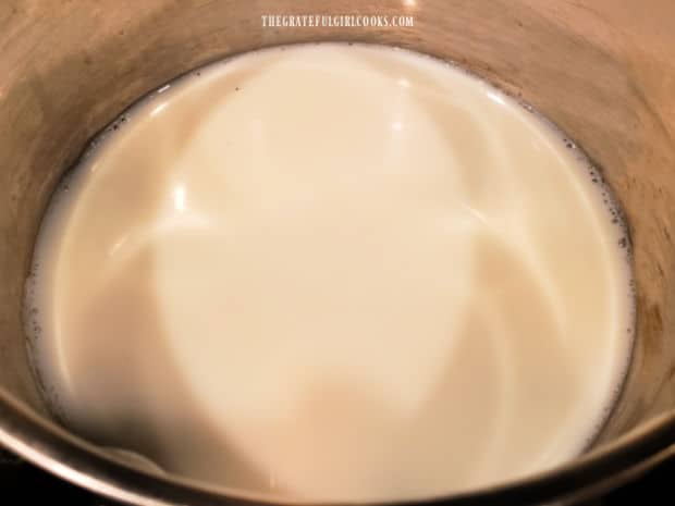 Milk and water are brought to a boil in a medium sized saucepan.