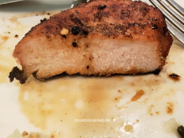 A picture of a sliced open, juicy hoisin marinated pork chop, on a plate.