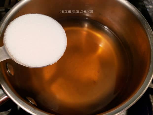 Granulated sugar and fresh lemon juice are added to the brewed mint tea.