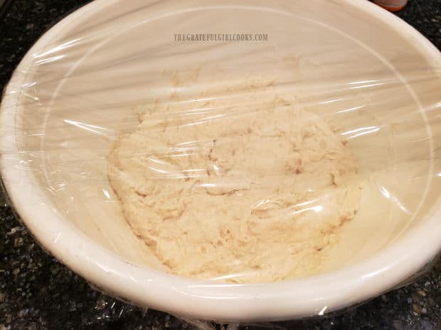 Bread dough is covered with plastic wrap and sits undisturbed at room temperature for 2 hours.