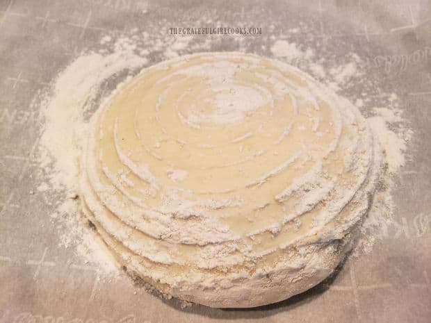 Bread dough ball, transferred from banneton basket onto parchment paper.