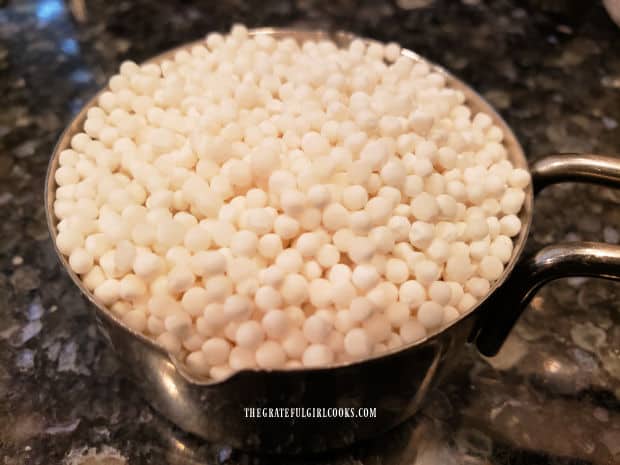 Tapioca pearls are measured in a measuring cup before cooking.